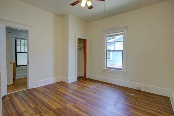 a view of a livingroom with wooden floor and a window