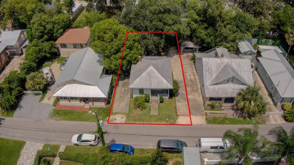 an aerial view of residential houses and car parked