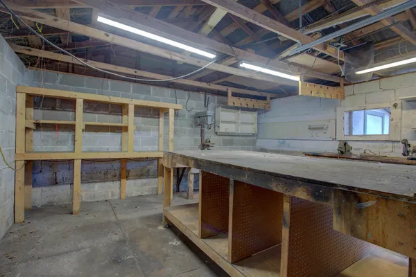 a view of a small yard in front of a house with large tree