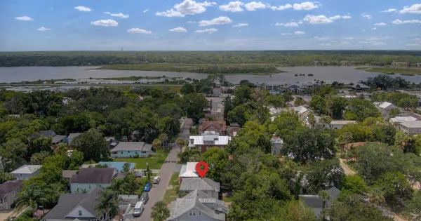 an aerial view of a house with a yard