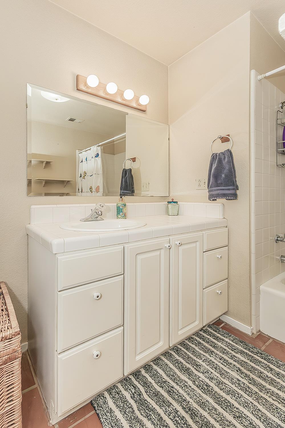 14815 Garlock Lane Prather, CA 93651 - Photo 30 of 80 a en suite bathroom with a sink and a mirror