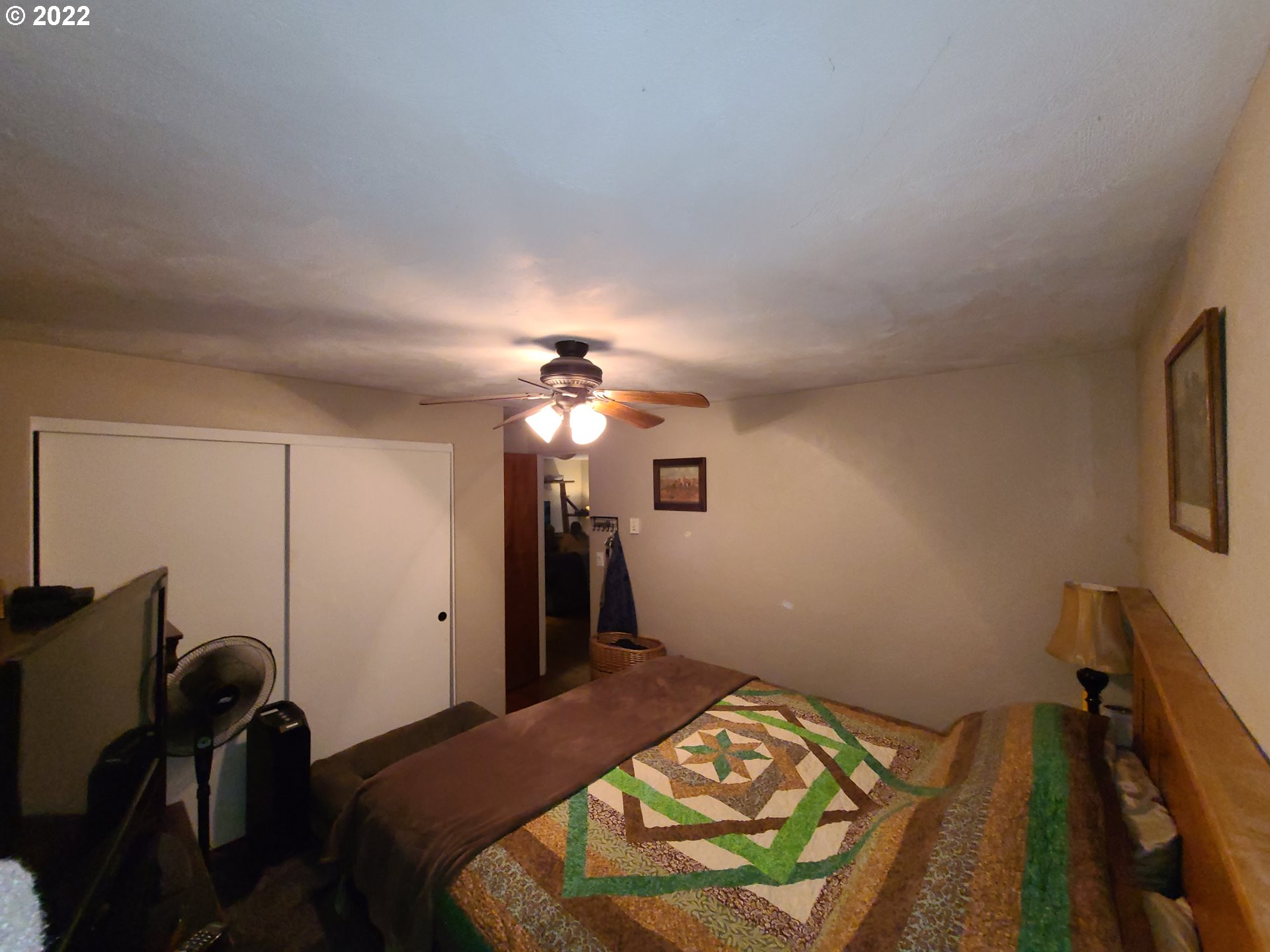 410 40th Street Springfield, OR 97478 - Photo 8 of 28 a bedroom with a bed and a chandelier