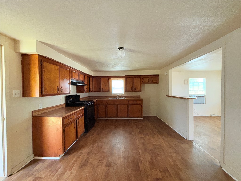 131 Algodon Street Taft, TX 78390 - Photo 6 of 10 a kitchen with granite countertop a sink cabinets and stainless steel appliances