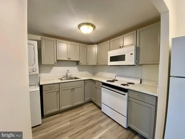 a kitchen with stainless steel appliances granite countertop a sink and stove top oven