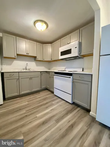 a kitchen with stainless steel appliances granite countertop a sink and cabinets