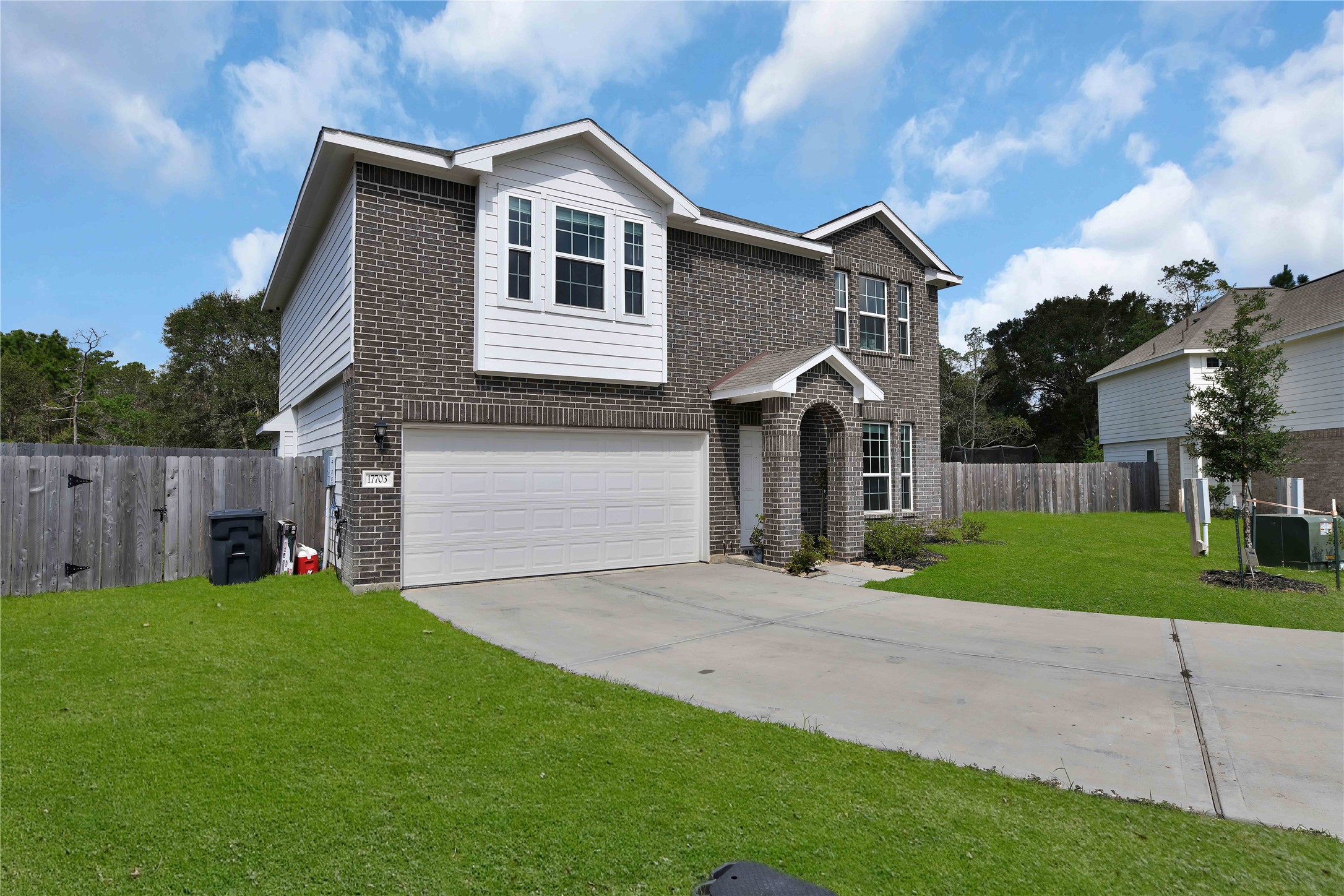 17703 Lion Heart Road Conroe, TX 77306 - Photo 2 of 26 a front view of house with yard and green space