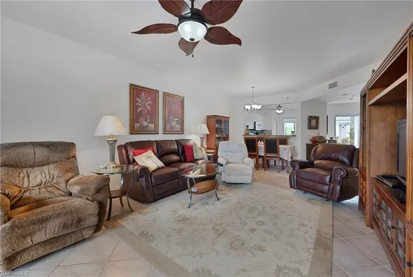 a living room with furniture ceiling fan and a rug