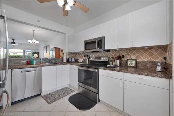 a kitchen with a sink cabinets and stainless steel appliances