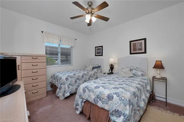 a bedroom with two beds and painting on the wall