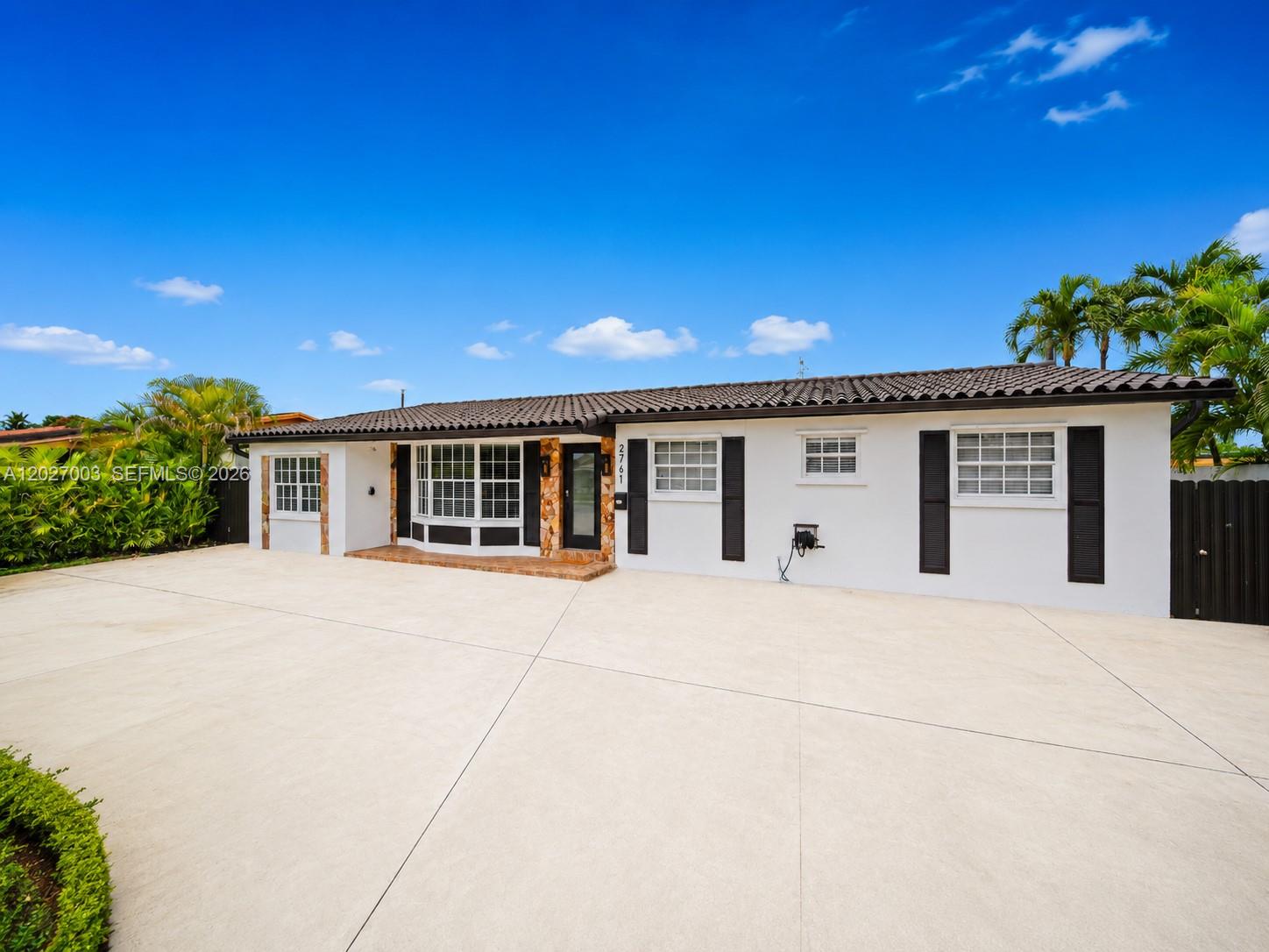 2761 Southwest 92nd Place Miami, FL 33165 - Photo 1 of 37 a front view of a house with a garage