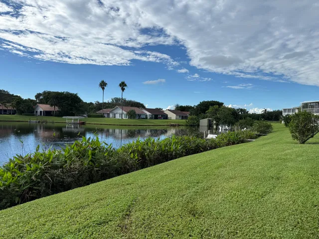 a view of a lake with houses in the back