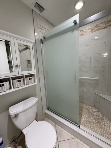 a white toilet sitting next to a bathroom sink