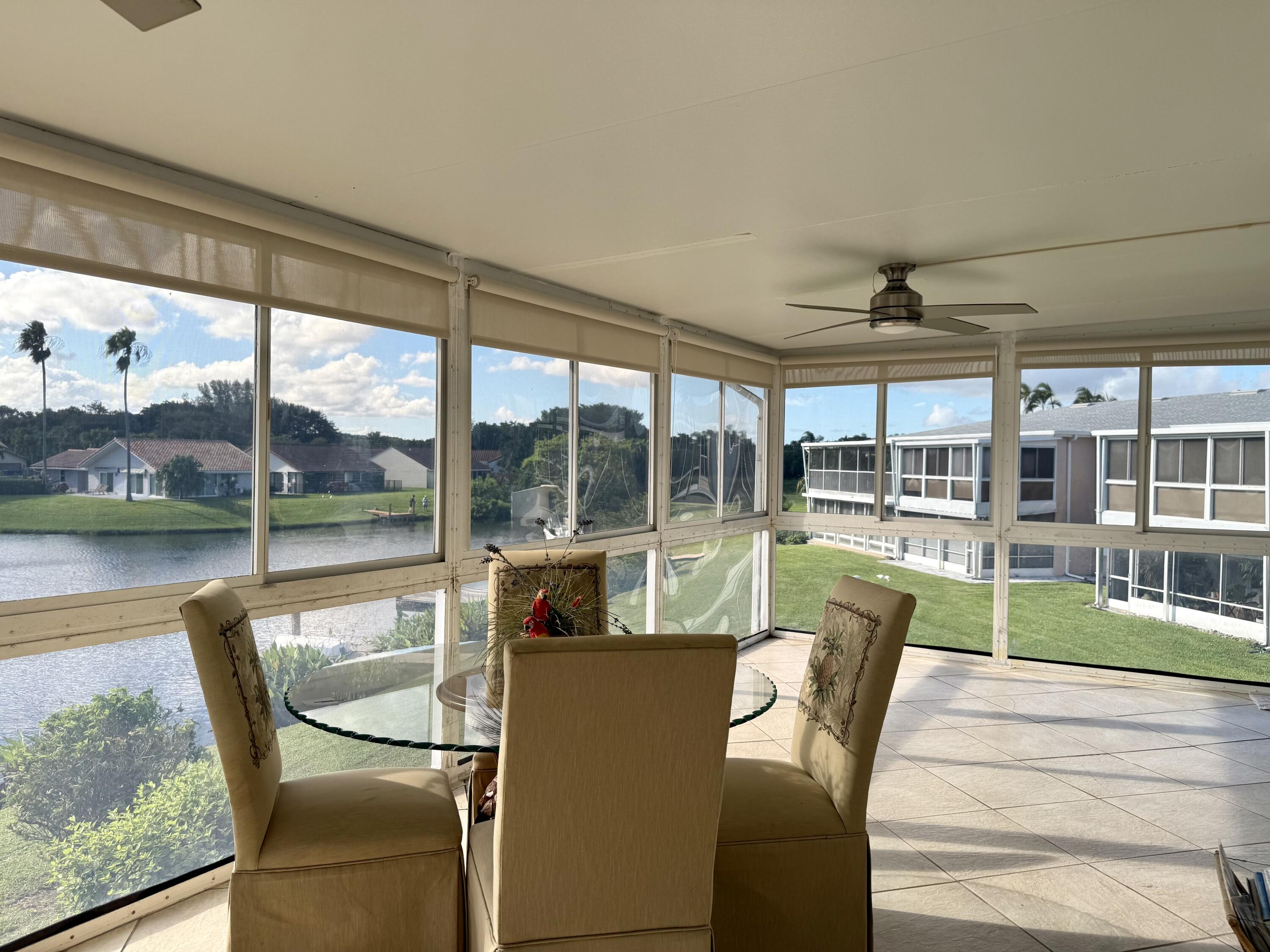 1720 Northwest 20th Avenue, Unit 204 Delray Beach, FL 33445 - Photo 5 of 30 a view of a porch with furniture and garden