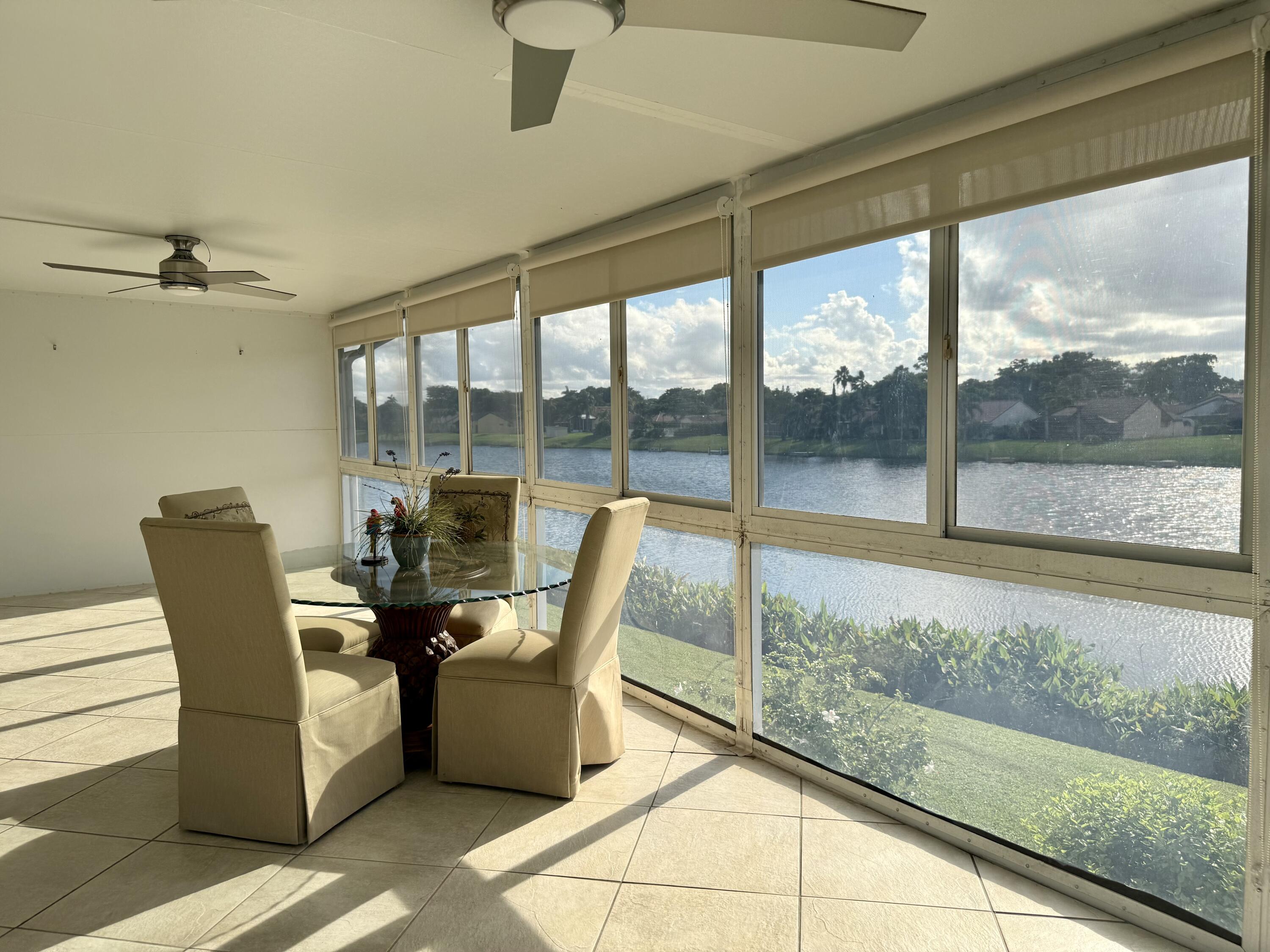 1720 Northwest 20th Avenue, Unit 204 Delray Beach, FL 33445 - Photo 6 of 30 a view of a dining room with furniture window and outside view