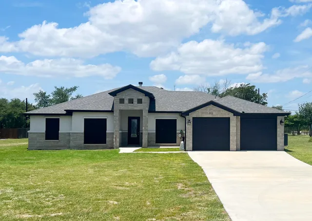 a front view of a house with yard