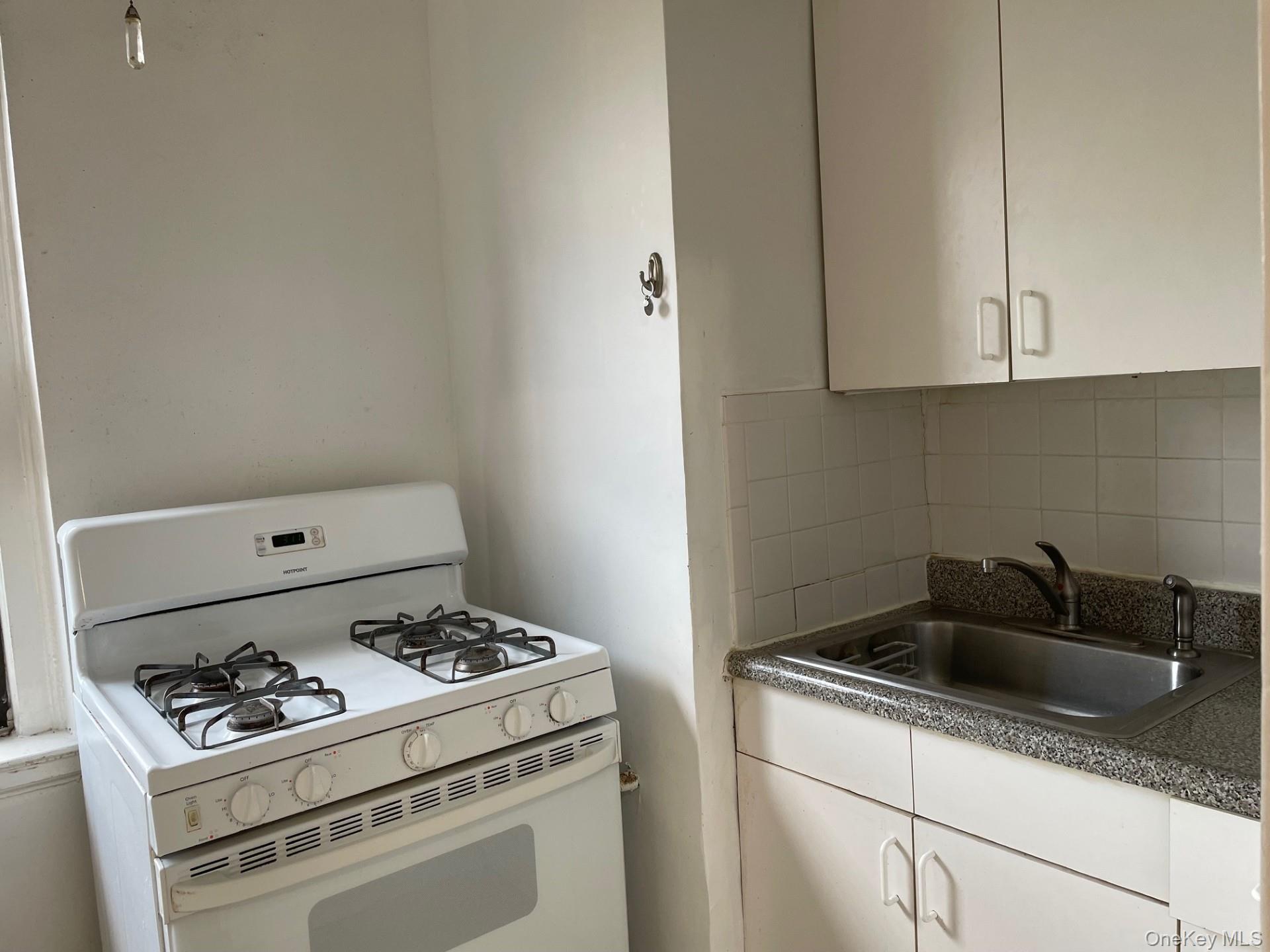 192 Garth Road, Unit 4N Scarsdale, NY 10583 - Photo 17 of 32 a white stove top oven sitting inside of a kitchen
