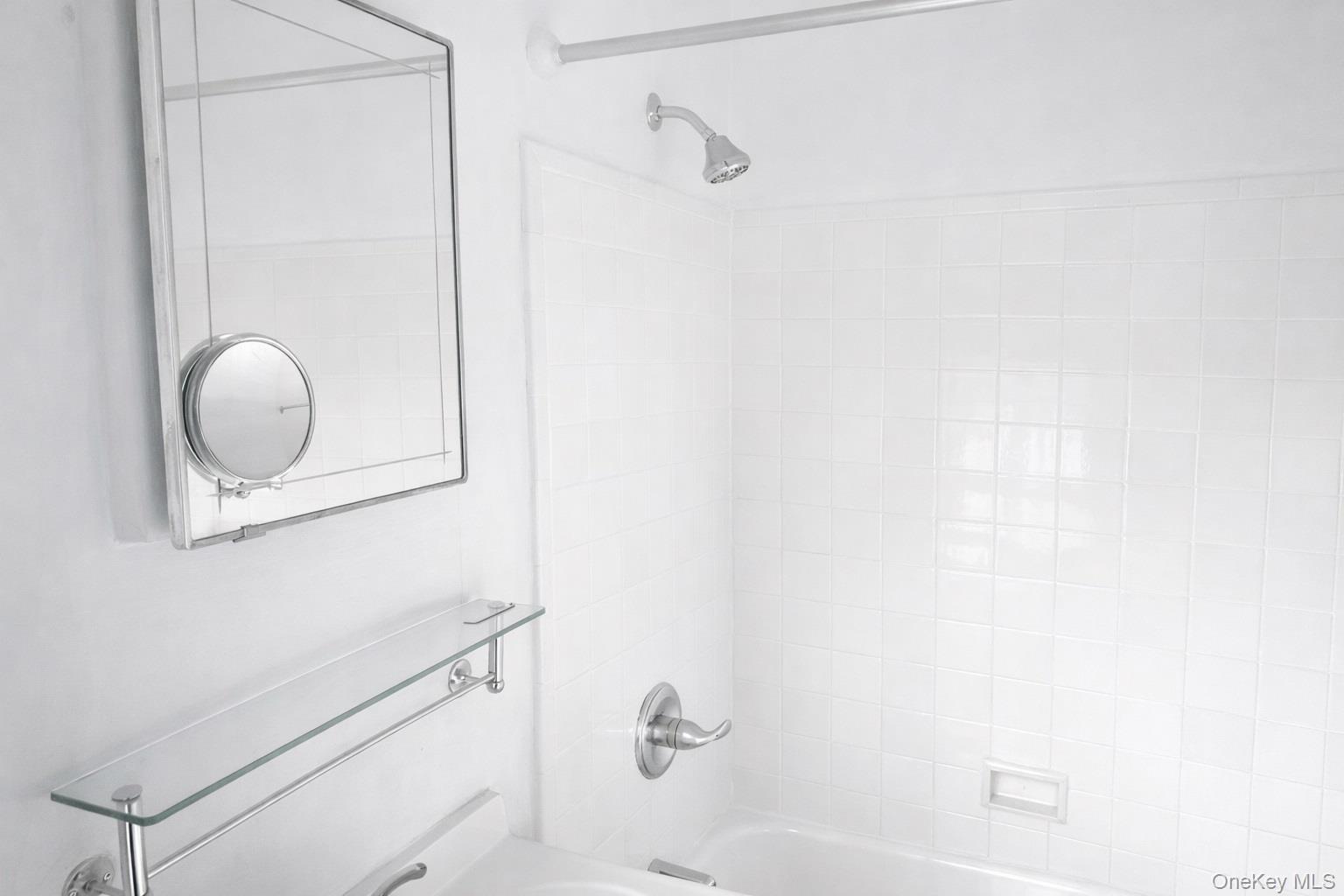 192 Garth Road, Unit 4N Scarsdale, NY 10583 - Photo 22 of 32 a bathroom with a bathtub and shower