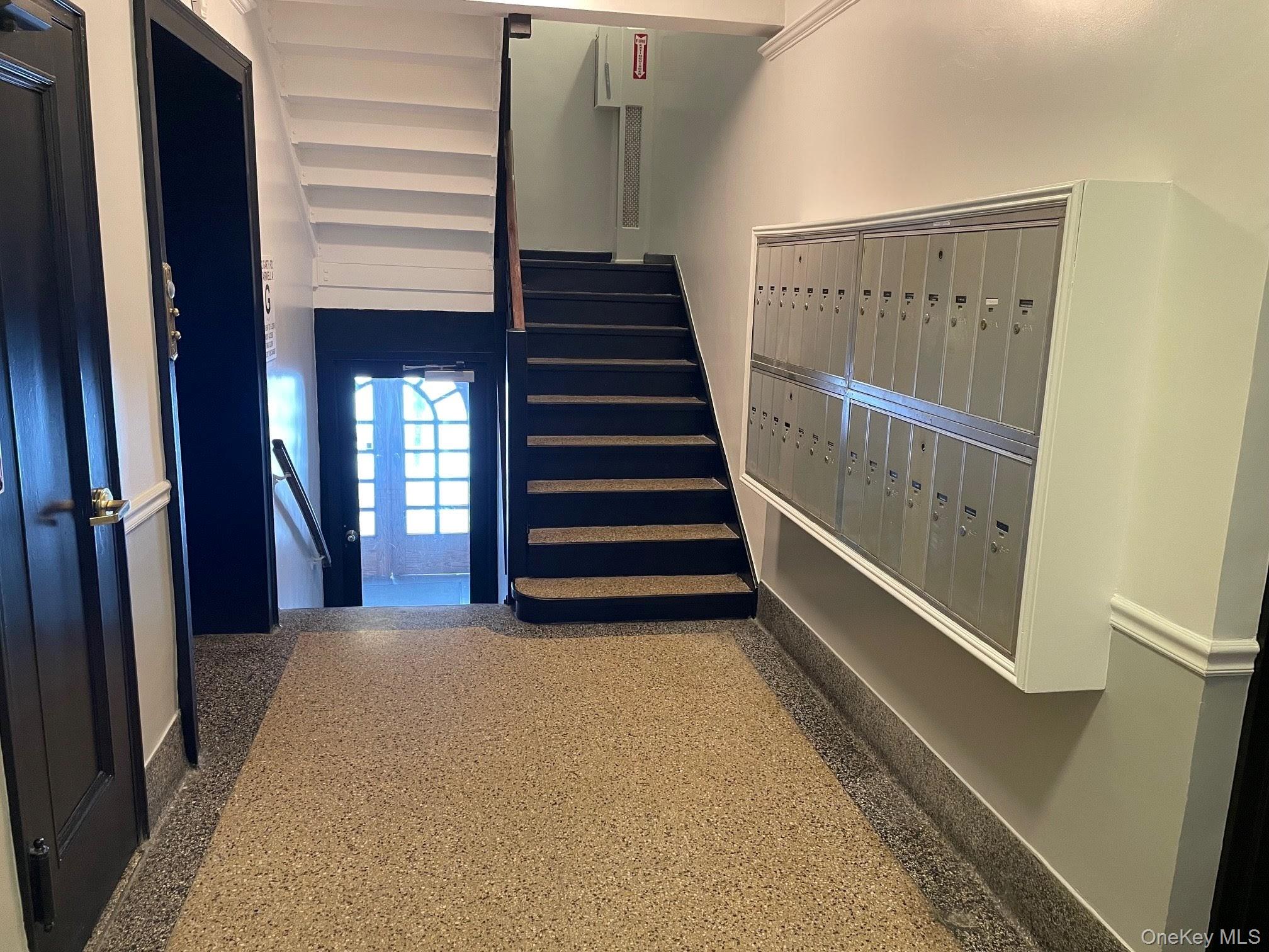 192 Garth Road, Unit 4N Scarsdale, NY 10583 - Photo 5 of 32 a view of a hallway with stairs and a window