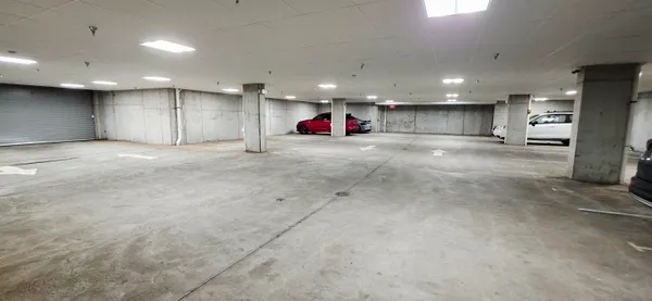 an empty room with kitchen and a refrigerator