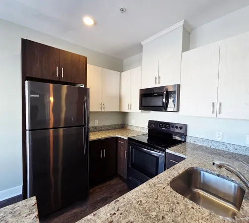 a kitchen with a refrigerator sink and microwave