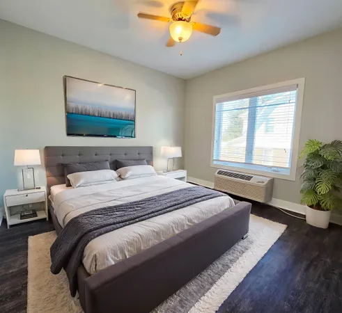 a bedroom with a bed and a chandelier