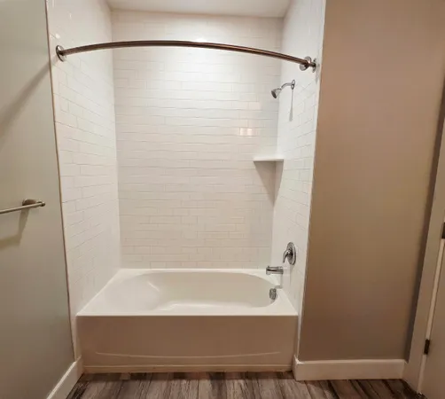 a bathroom with a bathtub and a shower