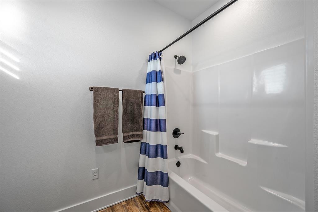 4509 Peach Tree Lane Kingston, OK 73439 - Photo 27 of 39 a bathroom with a bathtub and shower
