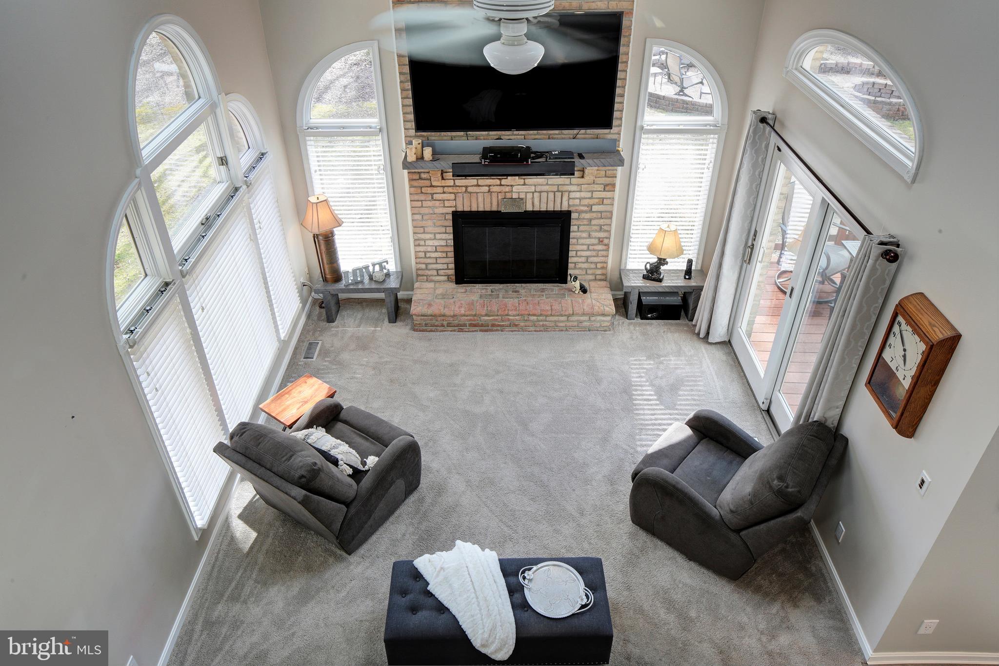 735 Carson Road Huntingtown, MD 20639 - Photo 14 of 37 a living room with furniture and a fireplace