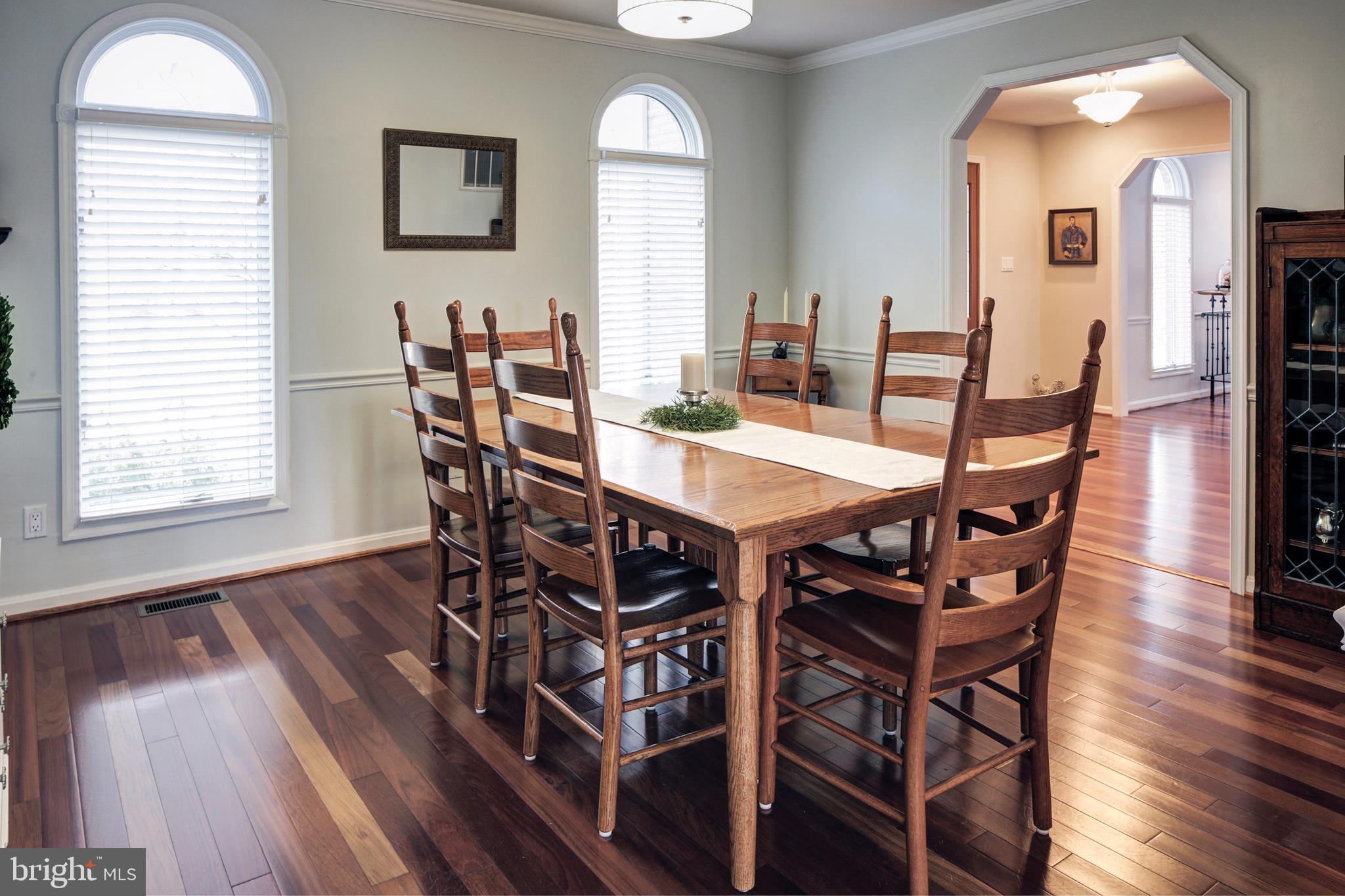 735 Carson Road Huntingtown, MD 20639 - Photo 3 of 37 a view of a dining room with furniture and wooden floor