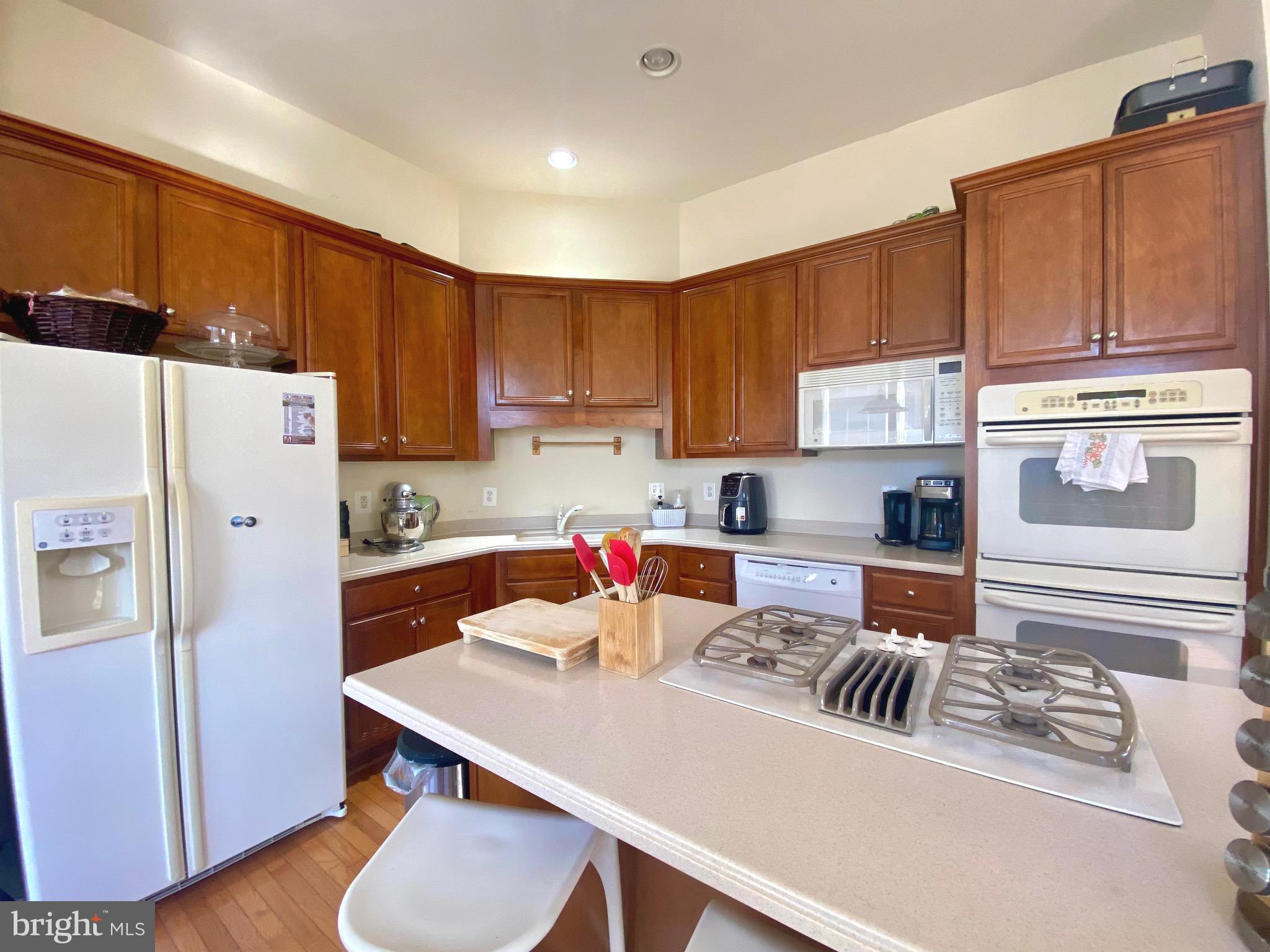 21975 Windover Drive Broadlands, VA 20148 - Photo 11 of 37 a kitchen with a refrigerator a stove a sink and cabinets