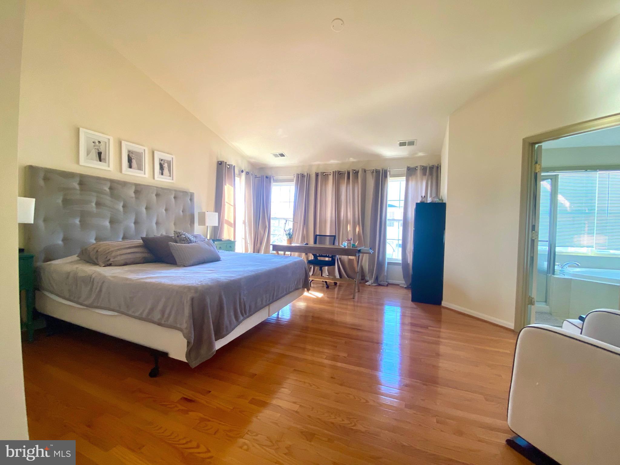 21975 Windover Drive Broadlands, VA 20148 - Photo 15 of 37 a spacious bedroom with a bed and wooden floor