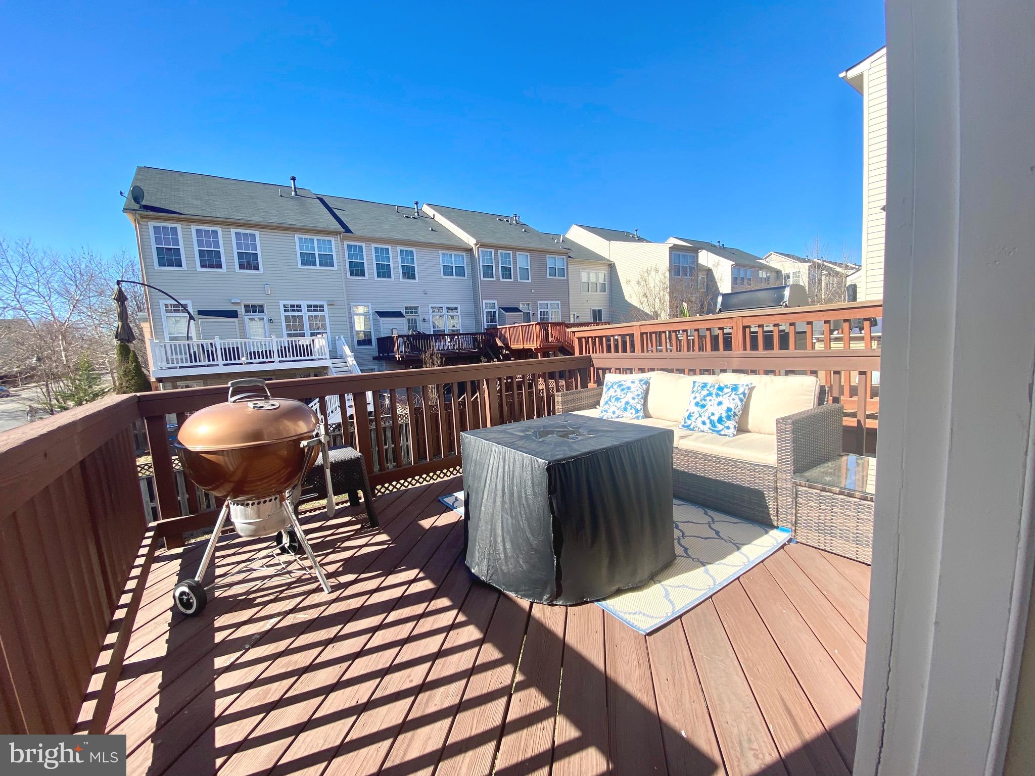 21975 Windover Drive Broadlands, VA 20148 - Photo 29 of 37 a balcony with wooden floor table and chairs