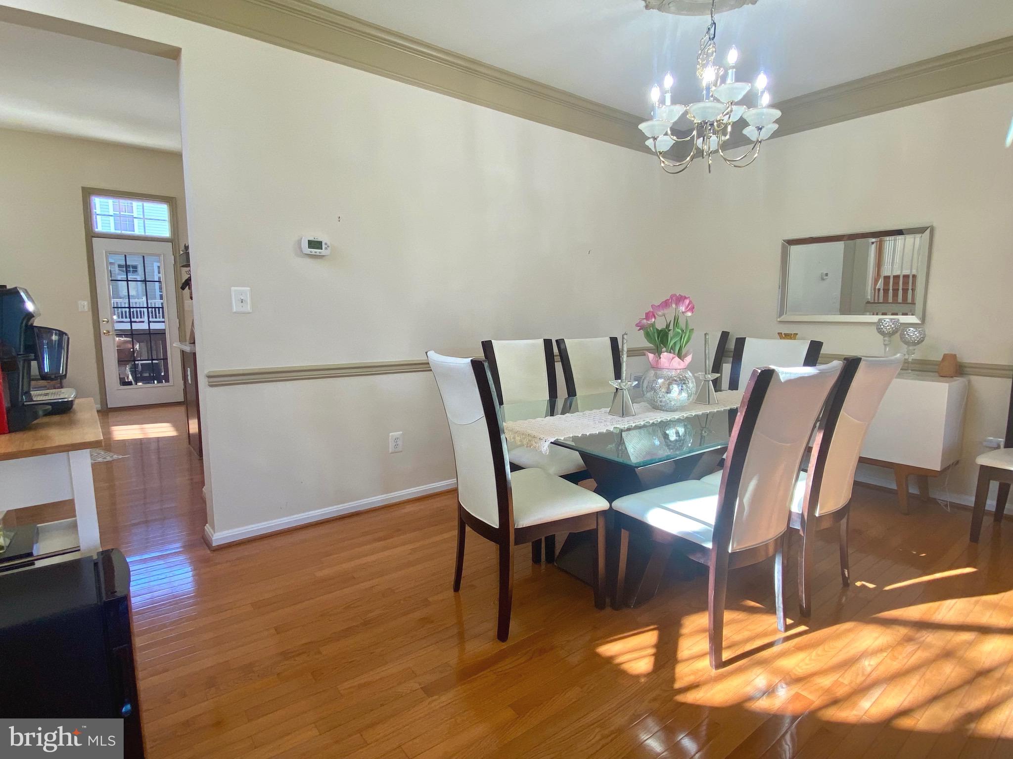 21975 Windover Drive Broadlands, VA 20148 - Photo 4 of 37 a view of a dining room with furniture and chandelier