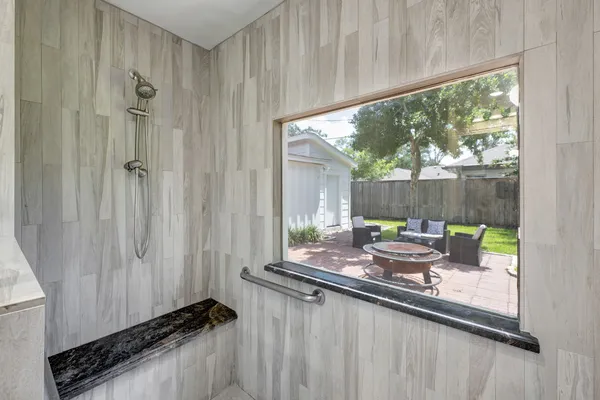 a kitchen with a large window in it and outdoor space