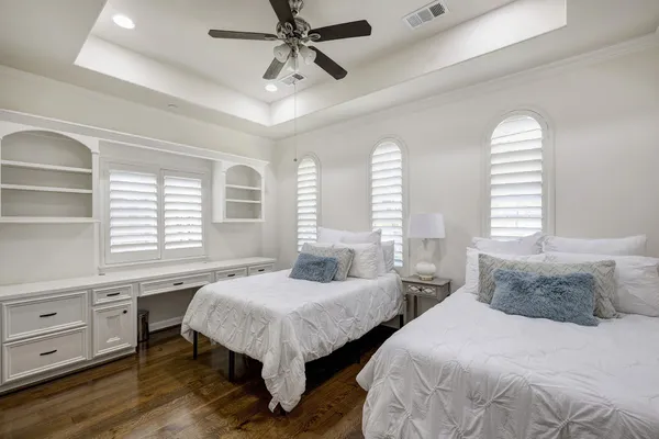 a bedroom with two beds and a large window