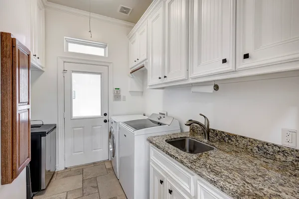 a kitchen with white cabinets and a sink