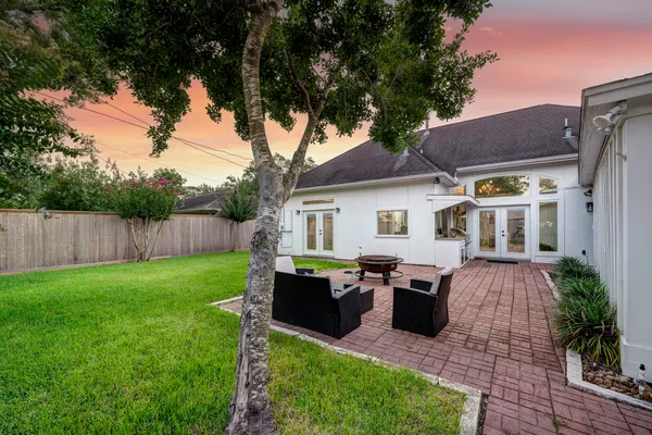 a front view of house with deck and yard