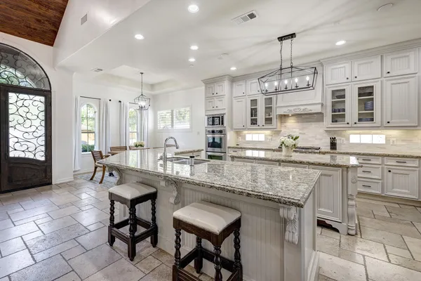 a kitchen with center island table and chairs in it