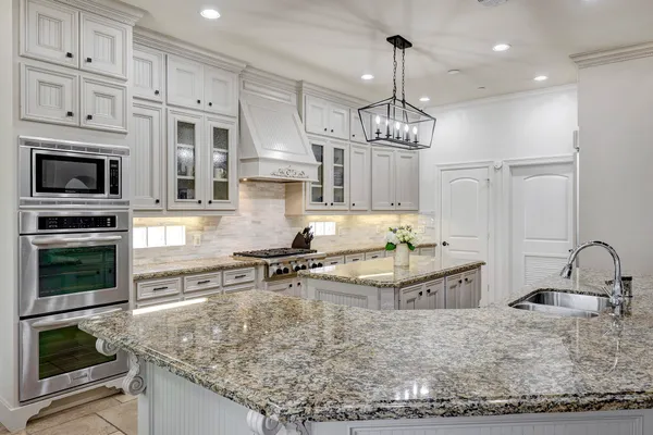 a kitchen with stainless steel appliances granite countertop a stove oven and a granite counter tops