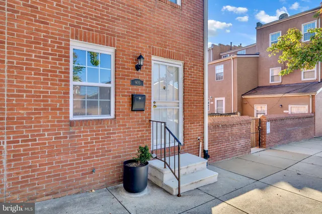 a view of a brick house with potted plants