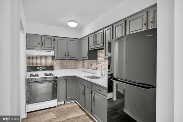 a kitchen with appliances cabinets and a sink