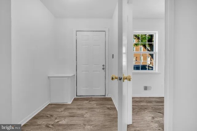 a view of a livingroom with a fireplace and window
