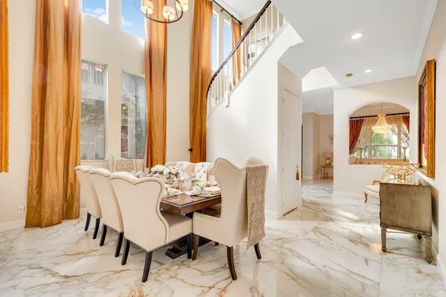 a living room with furniture and large windows