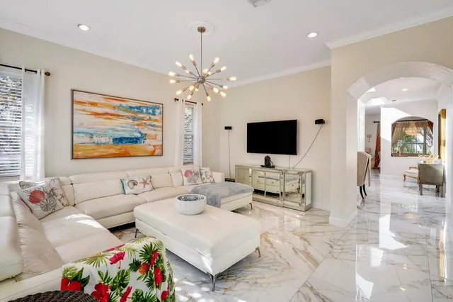 a living room with furniture and a chandelier