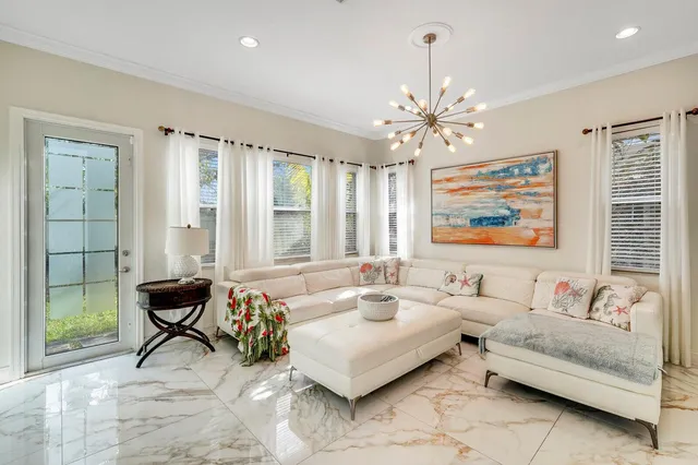 a kitchen with granite countertop a stove a oven a refrigerator and a dining table with wooden floor