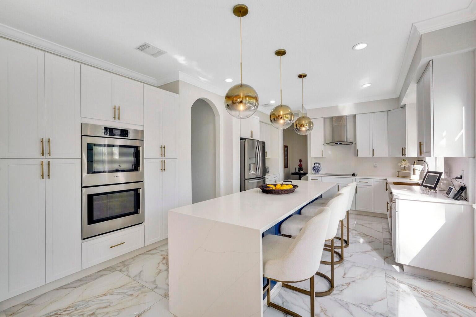 599 Cresta Circle West Palm Beach, FL 33413 - Photo 18 of 56 a kitchen with granite countertop a stove a oven a refrigerator and a dining table with wooden floor