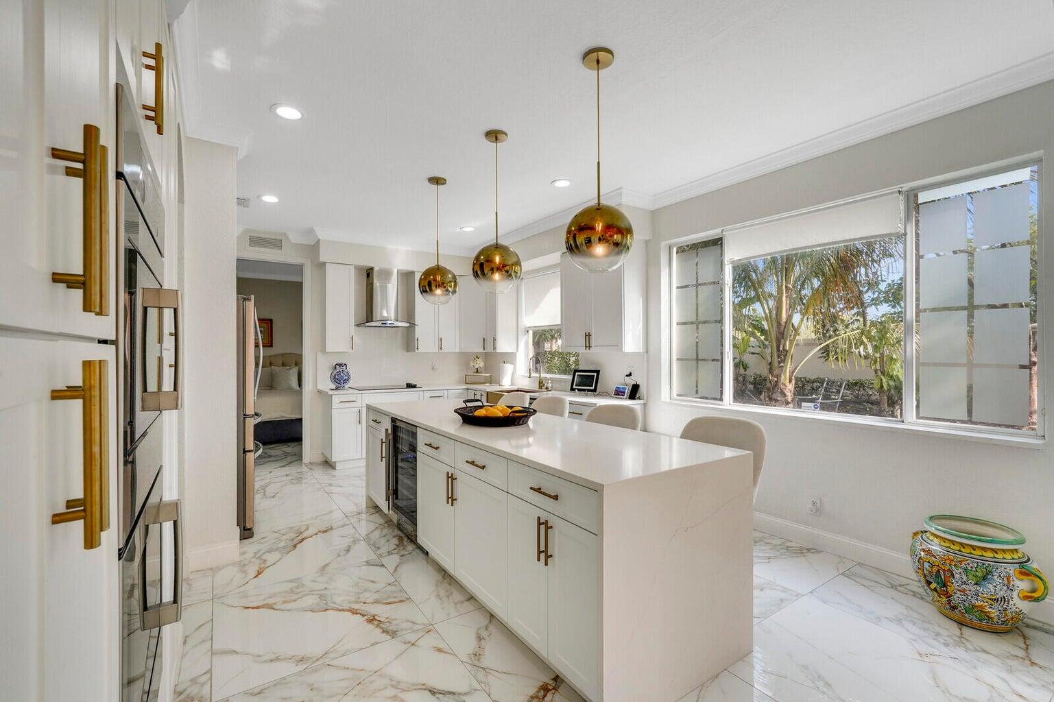 599 Cresta Circle West Palm Beach, FL 33413 - Photo 19 of 56 a kitchen with stainless steel appliances granite countertop a sink a stove and a refrigerator
