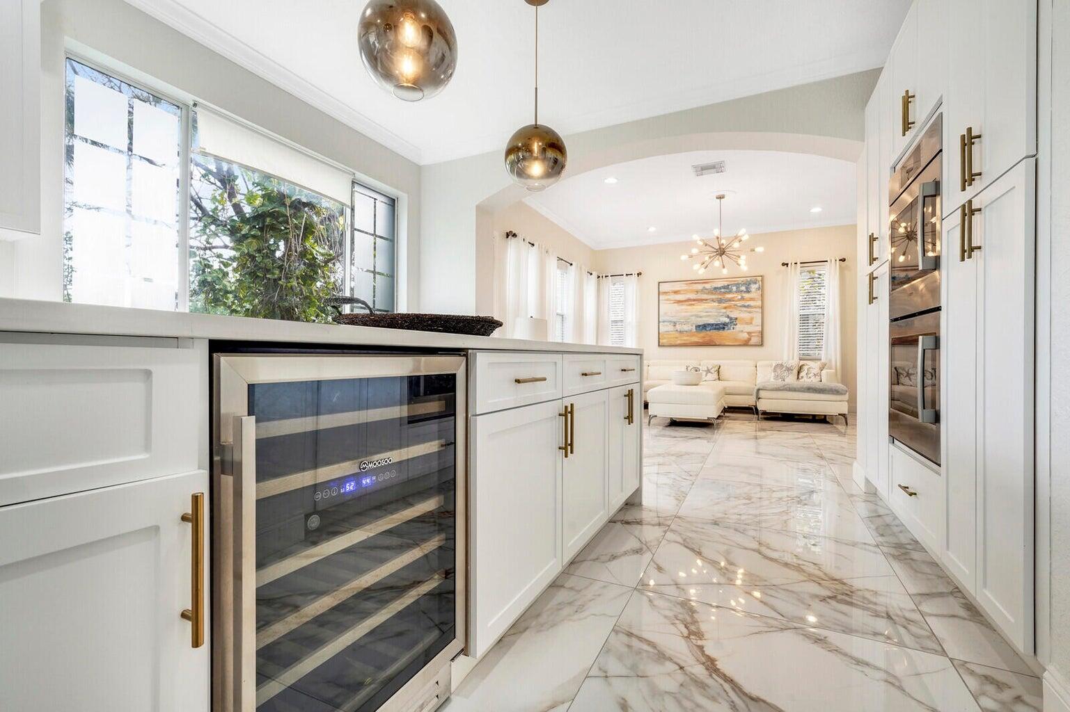 599 Cresta Circle West Palm Beach, FL 33413 - Photo 20 of 56 a kitchen with stainless steel appliances kitchen island granite countertop a stove a refrigerator and a window