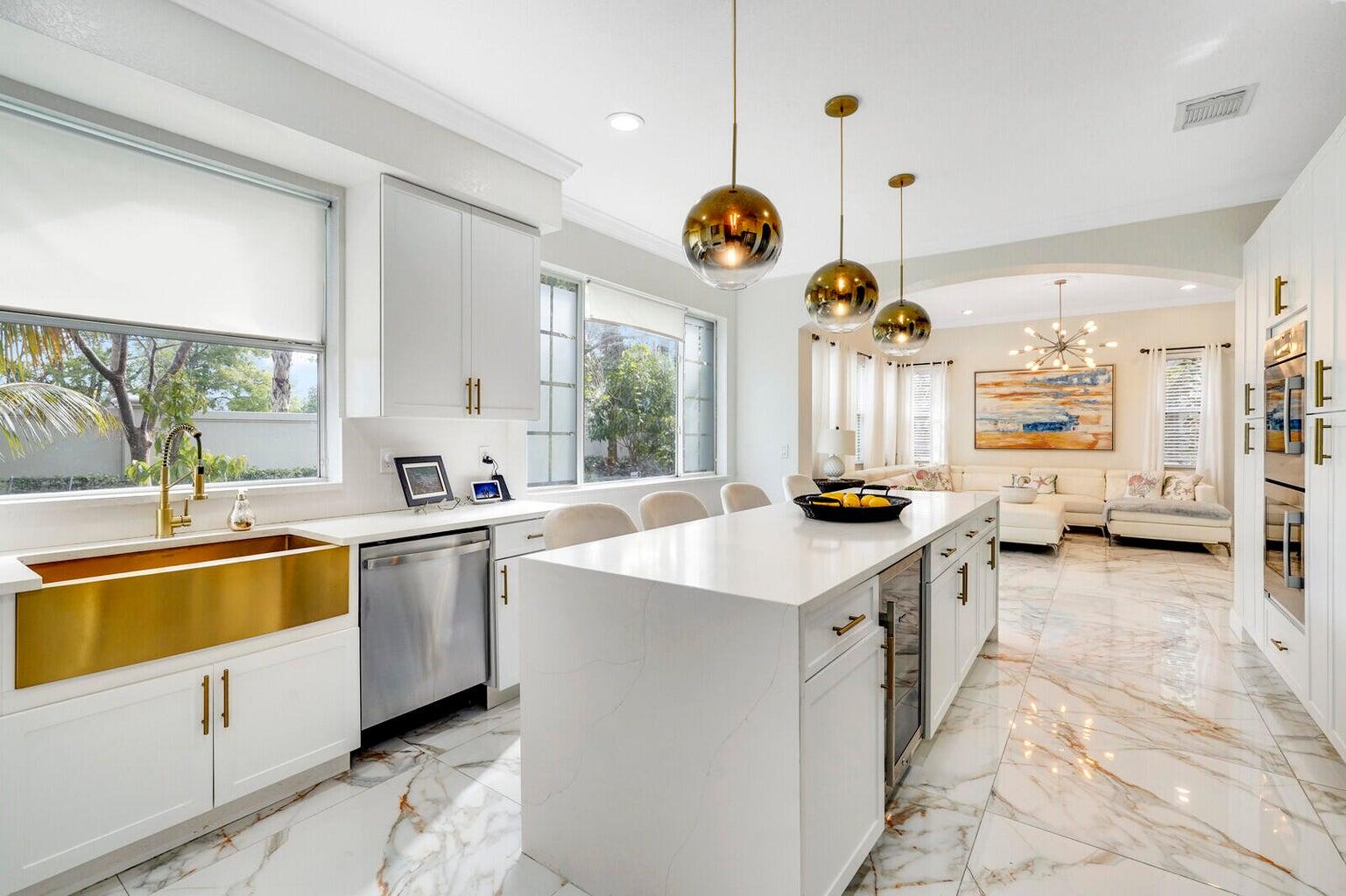 599 Cresta Circle West Palm Beach, FL 33413 - Photo 22 of 56 a kitchen with stainless steel appliances a stove a sink a chimney and a large window