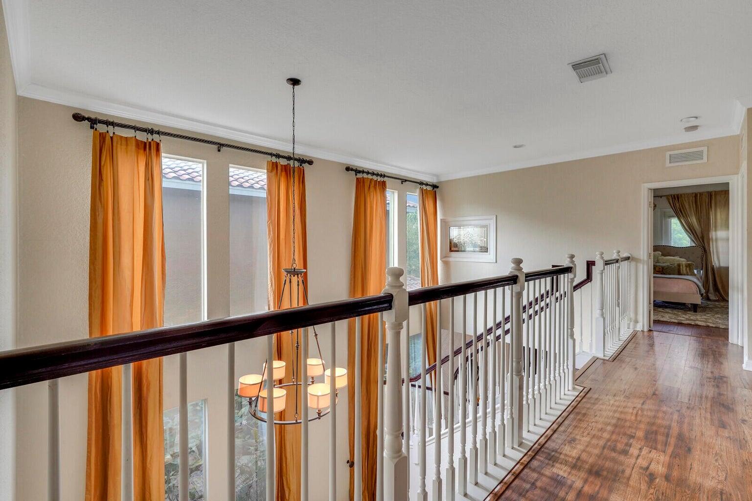 599 Cresta Circle West Palm Beach, FL 33413 - Photo 24 of 56 a view of a hallway with wooden floor and windows